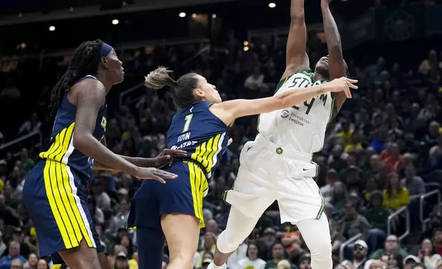 Seattle Storm guard Jewell Loyd (24) goes up to the basket against Dallas Wings forward Natasha Howard, left, and guard Sevgi Uzun (1) during the first half of a WNBA basketball game, Monday, July 1, 2024, in Seattle. (AP Photo/Lindsey Wasson)