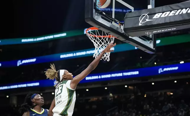 Seattle Storm guard Jordan Horston puts up a shot as Dallas Wings forward Natasha Howard, left, looks on during the first half of a WNBA basketball game, Monday, July 1, 2024, in Seattle. (AP Photo/Lindsey Wasson)