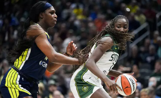 Seattle Storm center Ezi Magbegor, right, moves the ball against Dallas Wings center Teaira McCowan, left, during the first half of a WNBA basketball game, Monday, July 1, 2024, in Seattle. (AP Photo/Lindsey Wasson)