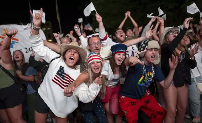 People celebrate while watching a live feed from Paris at the moment the International Olympic Committee awarded Salt Lake City the 2034 Winter Olympics, Wednesday, July 24, 2024, in Salt Lake City. (AP Photo/Spenser Heaps)