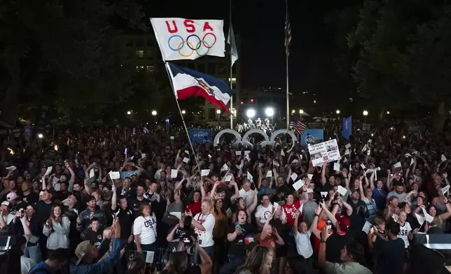 People celebrate while watching a live feed from Paris moments after the International Olympic Committee awarded Salt Lake City the 2034 Winter Olympics, Wednesday, July 24, 2024, in Salt Lake City. (AP Photo/Spenser Heaps)