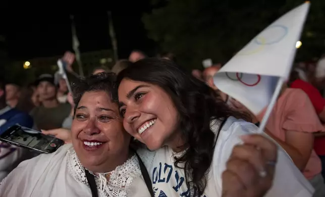 Patricia Huhem, left, and her daughter, Elisa Huhem, celebrate while watching a live feed from Paris moments after the International Olympic Committee awarded Salt Lake City the 2034 Winter Olympics, Wednesday, July 24, 2024, in Salt Lake City. (AP Photo/Spenser Heaps)