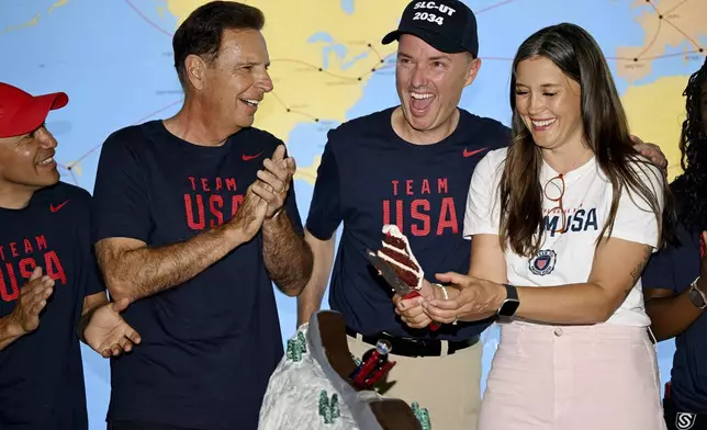 Olympic champion Derek Parra, Fraser Bullock, Utah Gov. Spencer Cox and Salt Lake City Mayor Erin Mendenhall and others laugh as they cut a cake as Utah's Olympic delegation gather for a sendoff celebration, Monday, July 22, 2024, at the Salt Lake International Airport prior to boarding a flight to France. (Scott G Winterton/The Deseret News via AP)