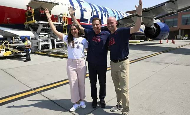 Salt Lake City Mayor Erin Mendenhall, Fraser Bullock and Utah Gov. Spencer Cox, from left, pose for a photo near the plane as Utah's Olympic delegation boards Delta Flight 2034, Monday, July 22, 2024, bound for Paris at the Salt Lake International Airport.. (Scott G Winterton/The Deseret News via AP)