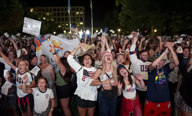 People celebrate while watching a live feed from Paris at the moment the International Olympic Committee awarded Salt Lake City the 2034 Winter Olympics, Wednesday, July 24, 2024, in Salt Lake City. (AP Photo/Spenser Heaps)