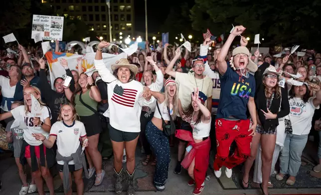 People celebrate while watching a live feed from Paris at the moment the International Olympic Committee awarded Salt Lake City the 2034 Winter Olympics, Wednesday, July 24, 2024, in Salt Lake City. (AP Photo/Spenser Heaps)