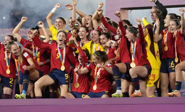 FILE - Spain players celebrate with the trophy at the end of the Women's World Cup soccer final between Spain and England at Stadium Australia in Sydney, Australia Aug. 20, 2023. Spain comes into the Olympics hoping to build off its Women’s World Cup success and move on from the tumult of the past. (AP Photo/Abbie Parr, File)