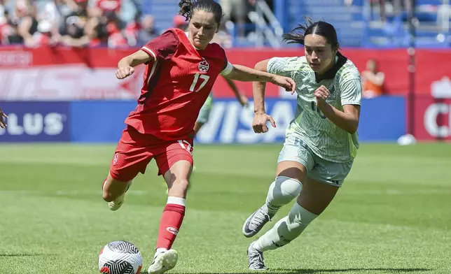 FILE - Canada's Jessie Fleming (17) breaks away from Mexico's Scarlett Camberos (10 during the first half of an international friendly soccer game in Montreal, Saturday, June 1, 2024. Canada opens the Olympic women's soccer tournament with New Zealand in Group A. Colombia and host France round out the group. (Graham Hughes/The Canadian Press via AP, File)