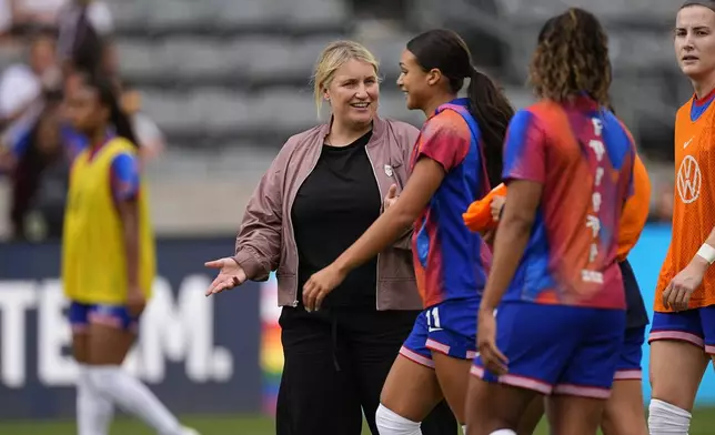 FILE - United States head coach Emma Hayes, front left, talks with forward Sophia Smith who warms up before facing South Korea in an international friendly soccer match June 1, 2024, in Commerce City, Colo. The U.S. women’s national team embarks on the 2024 Olympics in transition. The team’s slide from dominance on the world stage was evident by their early exit at last year’s Women’s World Cup. But they have a new coach in Hayes who is looking to shake things up. (AP Photo/David Zalubowski, File)