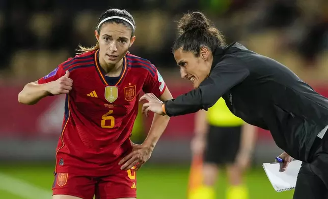 FILE - Spain's coach Montserrat Tome, right, gives instructions to Spain's Aitana Bonmatí during the women's Nations League semi finals soccer match between Spain and Netherlands, at La Cartuja stadium in Seville, Spain, Friday, Feb. 23, 2024. Spain can become the first team to win an Olympics after a World Cup title. (AP Photo/Jose Breton, File)
