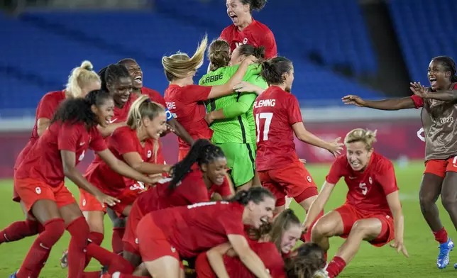 FILE - Canada player celebrate defeating Sweden for the gold medal in women's soccer at the Summer Olympics, Aug. 6, 2021, in Yokohama, Japan. Defending Olympic gold medalist Canada is looking to re-establish itself following last year’s Women’s World Cup disappointment. (AP Photo/Fernando Vergara, File)