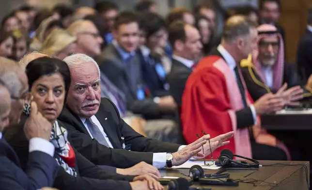 Palestinian foreign policy advisor Riad Malki and other members of the legal team take their seats before judges enter the International Court of Justice, or World Court, in The Hague, Netherlands, Friday July 19, 2024, where the United Nations top court is delivering a nonbinding advisory opinion Friday on the legality of Israel's 57-year occupation of lands sought for a Palestinian state, a ruling that could have more effect on international opinion than it will on Israeli policies. (AP Photo/Phil Nijhuis)