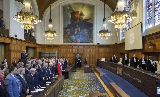 The Judges enter the International Court of Justice, or World Court, in The Hague, Netherlands, Friday July 19, 2024, where the United Nations top court is delivering a nonbinding advisory opinion Friday on the legality of Israel's 57-year occupation of lands sought for a Palestinian state, a ruling that could have more effect on international opinion than it will on Israeli policies. (AP Photo/Phil Nijhuis)