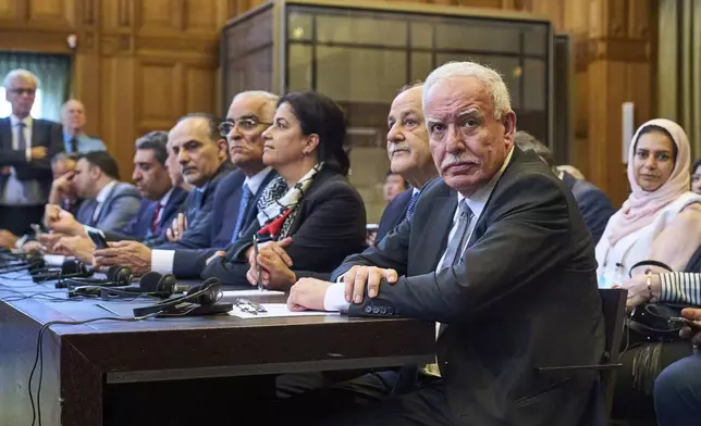 Palestinian foreign policy advisor Riad Malki and other members of the legal team take their seats before judges enter the International Court of Justice, or World Court, in The Hague, Netherlands, Friday July 19, 2024, where the United Nations top court is delivering a nonbinding advisory opinion Friday on the legality of Israel's 57-year occupation of lands sought for a Palestinian state, a ruling that could have more effect on international opinion than it will on Israeli policies. (AP Photo/Phil Nijhuis)