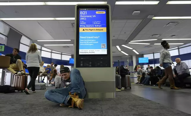 An information display near United gates shows a flight delay at Chicago O'Hare International Airport in Chicago, Friday, July 19, 2024, after software issues delayed and canceled flights globally. (AP Photo/Carolyn Kaster)