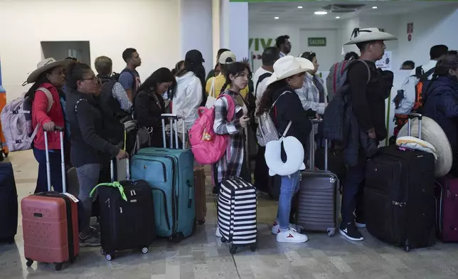 Passengers wait at Benito Juárez International Airport in Mexico City, Friday, July 19, 2024. Some flights were canceled and others were delayed amid a global technology outage. (AP Photo/Marco Ugarte)