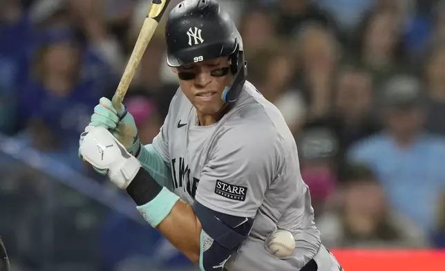 New York Yankees' Aaron Judge is hit by a pitch during fourth-inning baseball game action against the Toronto Blue Jays in Toronto, Sunday, June 30, 2024. (Frank Gunn/The Canadian Press via AP)