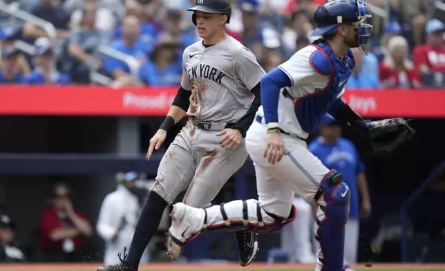 New York Yankees' Ben Rice (93) scores on a single from teammate DJ LeMahieu during the second inning of a baseball game against the Toronto Blue Jays in Toronto, Sunday, June 30, 2024. (Frank Gunn/The Canadian Press via AP)