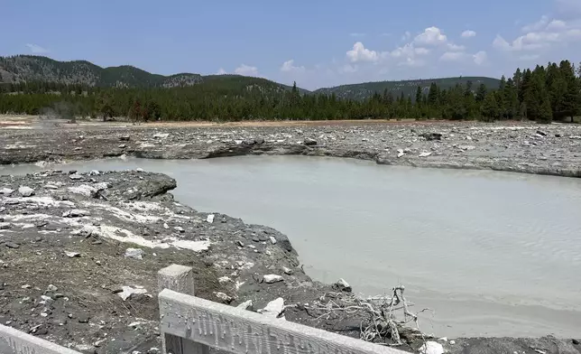 In this photo released by the National Park Service, debris litter the damaged Biscuit Basin boardwalks after a hydrothermal explosion at Biscuit Basin in Yellowstone National Park, Wyo., Tuesday, July 23, 2024. (National Park Service via AP)