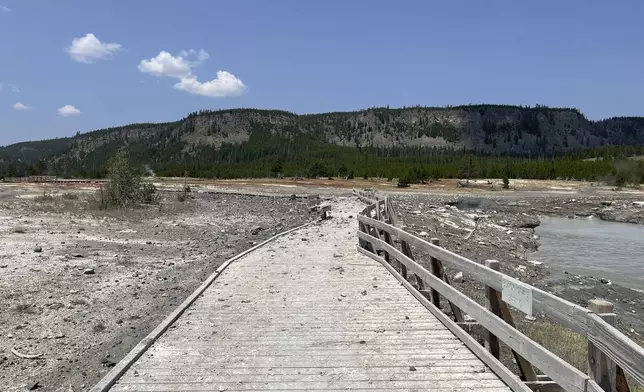 In this photo released by the National Park Service, debris litter the damaged Biscuit Basin boardwalks after a hydrothermal explosion at Biscuit Basin in Yellowstone National Park, Wyo., Tuesday, July 23, 2024. (National Park Service via AP)