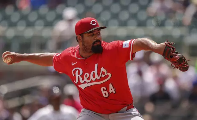 Cincinnati Reds pitcher Tony Santillan throws in the eighth inning of the first baseball game of a doubleheader against the Atlanta Braves, Wednesday, July 24, 2024, in Atlanta. (AP Photo/Jason Allen)