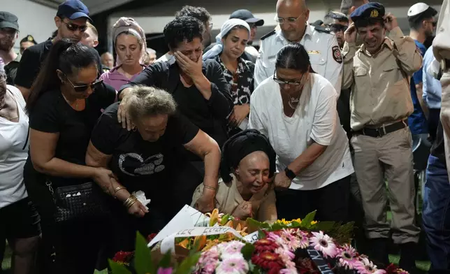 ADDS MOTHER"S NAME The mother, Iris Shitrit, center, of Petty Officer 1st Class David Moshe Ben Shitrit, who was killed on a Hezbollah attack, mourns during the funeral of her son at the Mount Herzl military cemetery in Jerusalem, Sunday, Aug. 25, 2024. (AP Photo/Ohad Zwigenberg)