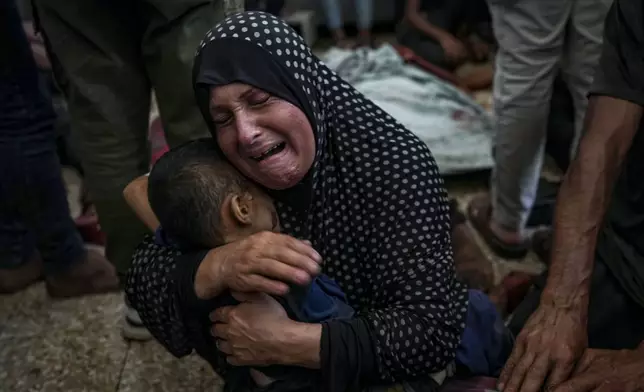 ADDS PALESTINIAN WOMAN'S NAME - Faten Mreish mourns her son who was killed in the Israeli bombardment of the Gaza Strip at a hospital morgue in Deir al-Balah, Wednesday, Aug. 28, 2024. (AP Photo/Abdel Kareem Hana)