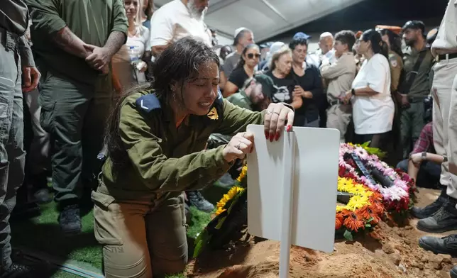 ADDS SISTER'S NAME Hodaya, the sister of Petty Officer 1st Class David Moshe Ben Shitrit, who was killed on a Hezbollah attack, mourns during his funeral at the Mount Herzl military cemetery in Jerusalem, Sunday, Aug. 25, 2024. (AP Photo/Ohad Zwigenberg)