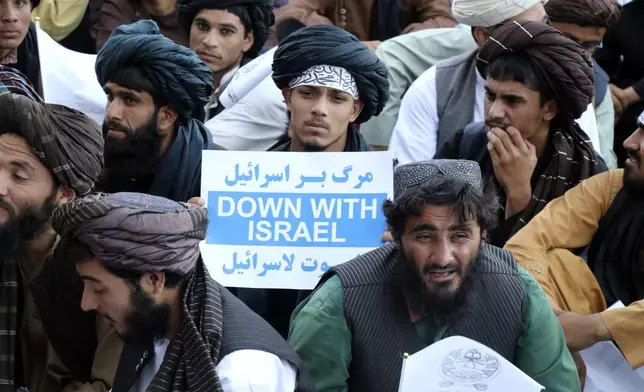 Afghan people attend a demonstration to condemn the killing of Hamas leader Ismail Haniyeh, who was killed in Tehran, and show solidarity with Palestinian people living in Gaza, in the Herat province of western Afghanistan, Wednesday, Aug. 7, 2024. (AP Photo/Omid Haqjoo)