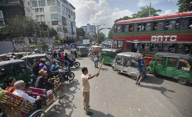 Volunteers manage road traffic in Dhaka, Bangladesh, Tuesday, Aug. 6, 2024. (AP Photo/Rajib Dhar)