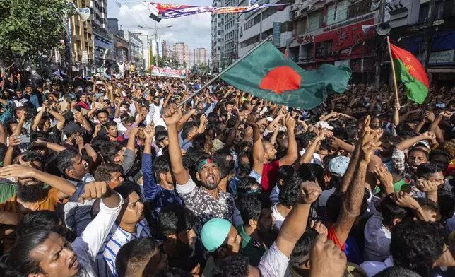 People gather in front of the Bangladesh Nationalist Party (BNP) headquarters during a rally in Dhaka, Bangladesh, Wednesday, Aug. 7, 2024. (AP Photo/Rajib Dhar)