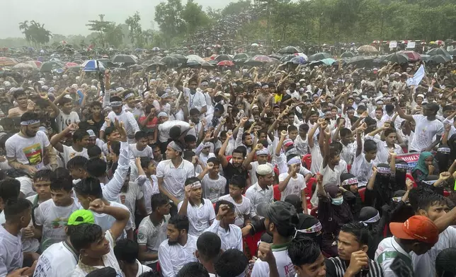 Hundreds of Rohingyas gather in the rain to demand safe return to Myanmar's Rakhine state as they mark the seventh anniversary of their mass exodus from Myanmar at their refugee camp at Kutupalong in Cox's Bazar district, Bangladesh, Sunday, Aug. 25, 2024. (AP Photo/ Shafiqur Rahman)