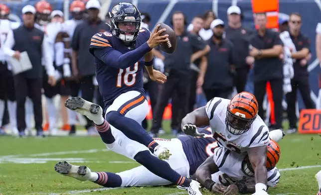 Chicago Bears quarterback Caleb Williams (18) breaks away from a tackle against the Cincinnati Bengals during the first half of an NFL preseason football game, Saturday, Aug. 17, 2024, at Soldier Field in Chicago. (AP Photo/Charles Rex Arbogast)