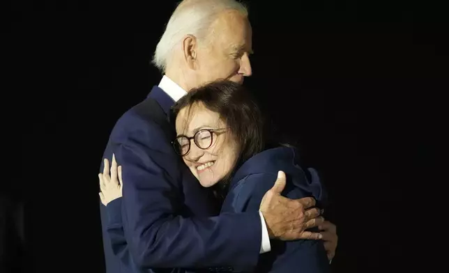 President Joe Biden, left, hugs Alsu Kurmasheva at Andrews Air Force Base, Md., following her release as part of a 24-person prisoner swap between Russia and the United States, Thursday, Aug. 1, 2024. (AP Photo/Alex Brandon)