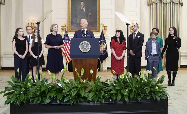 President Joe Biden, center, delivers remarks on a prisoner swap with Russia from the State Dining Room of the White House, Thursday, Aug. 1, 2024, in Washington. (AP Photo/Evan Vucci)