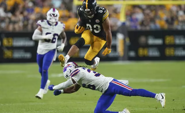 Pittsburgh Steelers tight end Connor Heyward (83) leaps over Buffalo Bills safety Kendall Williamson (36) during the second half of an NFL preseason football game, Saturday, Aug. 17, 2024, in Pittsburgh. (AP Photo/Matt Freed)