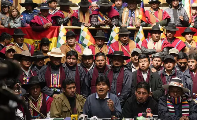 Former President Evo Morales, below center, the current MAS party president, gives a news conference in El Alto, Bolivia, Tuesday, Aug. 20, 2024. (AP Photo/Juan Karita)