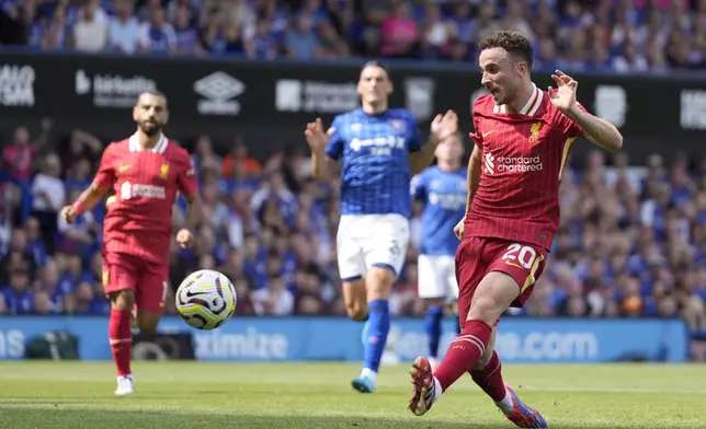 Liverpool's Diogo Jota scores his side's first goal during the English Premier League soccer match between Ipswich Town and Liverpool at Portman Road stadium in Ipswich, England, Saturday, Aug. 17, 2024. (AP Photo/Alastair Grant)