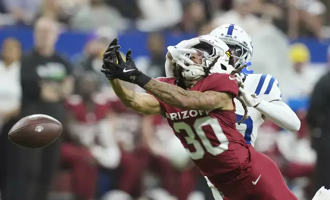 Arizona Cardinals wide receiver Xavier Weaver (30) is unable to make a catch on a pass as Indianapolis Colts cornerback Jaylin Simpson defends during the second half of a preseason NFL football game, Saturday, Aug. 17, 2024, in Indianapolis. (AP Photo/Darron Cummings)