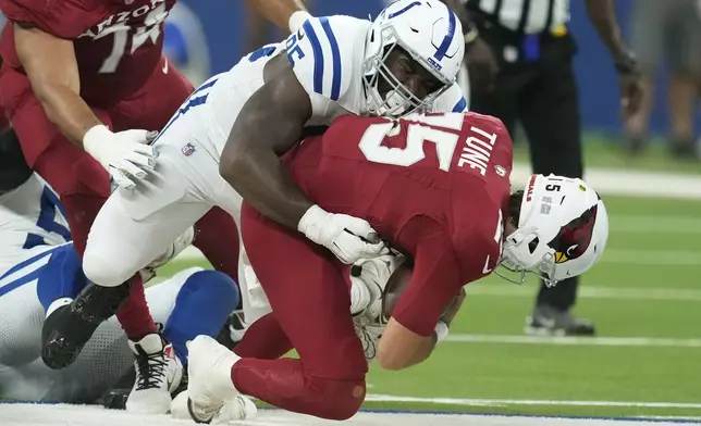 Indianapolis Colts defensive tackle Adetomiwa Adebawore, left, sacks Arizona Cardinals quarterback Clayton Tune, right, during the first half of a preseason NFL football game, Saturday, Aug. 17, 2024, in Indianapolis. (AP Photo/Darron Cummings)