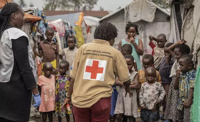 Red Cross officials create awareness around mpox in the Don Bosco refugee camp in Goma, Democratic Republic of Congo, Thursday, Aug. 22, 2023. (AP Photo/Moses Sawasawa)