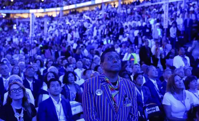 Delegates watch a presentation during the Democratic National Convention Thursday, Aug. 22, 2024, in Chicago. (AP Photo/Brynn Anderson)