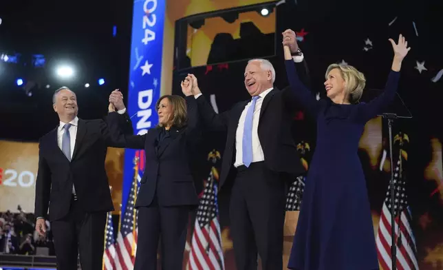 Democratic presidential nominee Vice President Kamala Harris with Second gentleman Douglas Emhoff and Democratic vice presidential candidate Minnesota Gov. Tim Walz with his wife Gwen Walz celebrate during the Democratic National Convention Thursday, Aug. 22, 2024, in Chicago. (AP Photo/Erin Hooley)