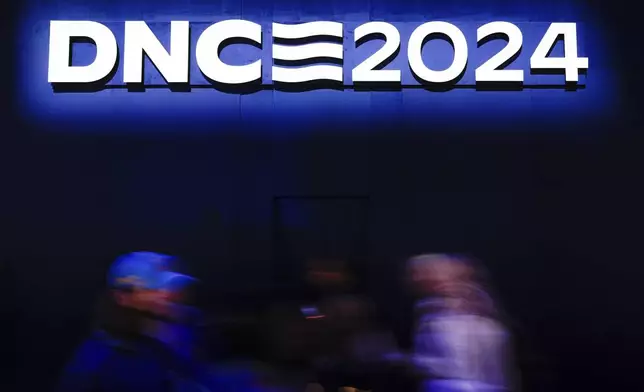 Delegates arrive at the Democratic National Convention Tuesday, Aug. 20, 2024, in Chicago. (AP Photo/Paul Sancya)