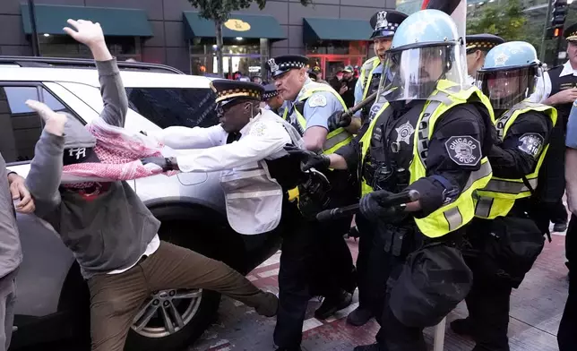 Demonstrators clash with police near the Israeli Consulate during the Democratic National Convention Tuesday, Aug. 20, 2024, in Chicago. (AP Photo/Alex Brandon)