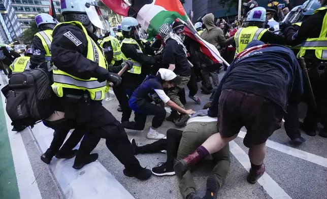 Demonstrators clash with police near the Israeli Consulate during the Democratic National Convention Tuesday, Aug. 20, 2024, in Chicago. (AP Photo/Frank Franklin II)