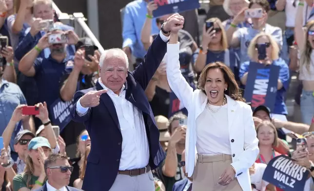 Democratic presidential nominee Vice President Kamala Harris is welcomed by Democratic vice presidential nominee Minnesota Gov. Tim Walz, before she delivers remarks at a campaign event, Wednesday, Aug. 7, 2024, in Eau Claire, Wisc. (AP Photo/Charles Rex Arbogast)