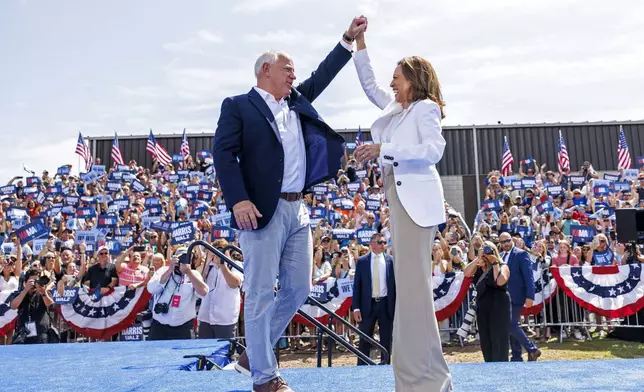 Democratic presidential nominee Vice President Kamala Harris is welcomed by running mate Democratic vice presidential nominee Minnesota Gov. Tim Walz before she delivers remarks at a campaign rally in Eau Claire, Wis., Wednesday, Aug. 7, 2024. (Kerem Yücel/Minnesota Public Radio via AP)