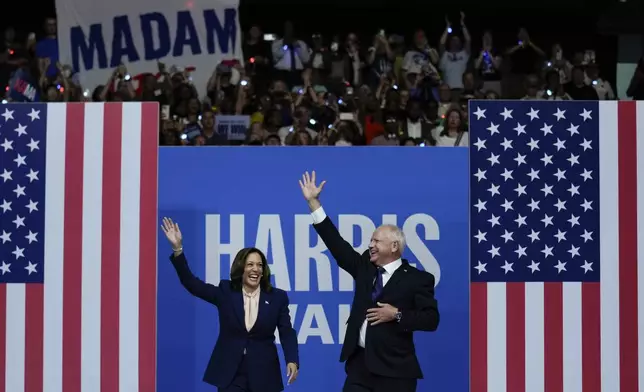 Democratic presidential nominee Vice President Kamala Harris and her running mate Minnesota Gov. Tim Walz arrive at a campaign rally in Philadelphia, Tuesday, Aug. 6, 2024. (AP Photo/Matt Rourke)