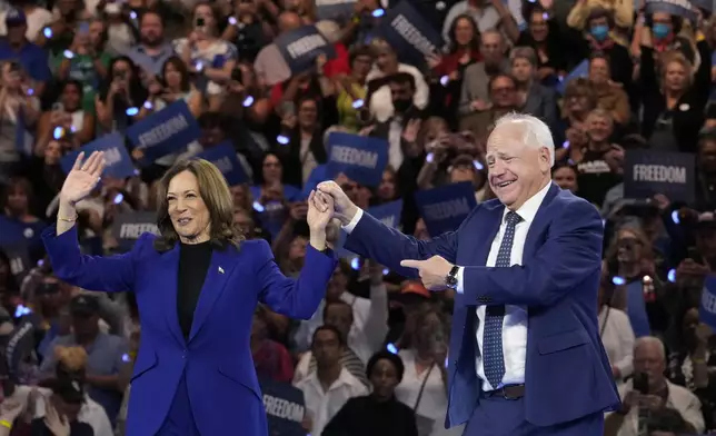 Democratic presidential nominee Vice President Kamala Harris and running mate Minnesota Gov. Tim Walz appear at the Fiserv Forum during a campaign rally in Milwaukee, Tuesday, Aug. 20, 2024. (AP Photo/Jacquelyn Martin)